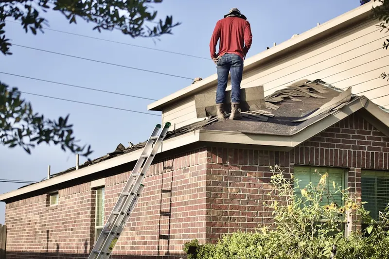 Professional roofer working on a residential roof in Champion Park